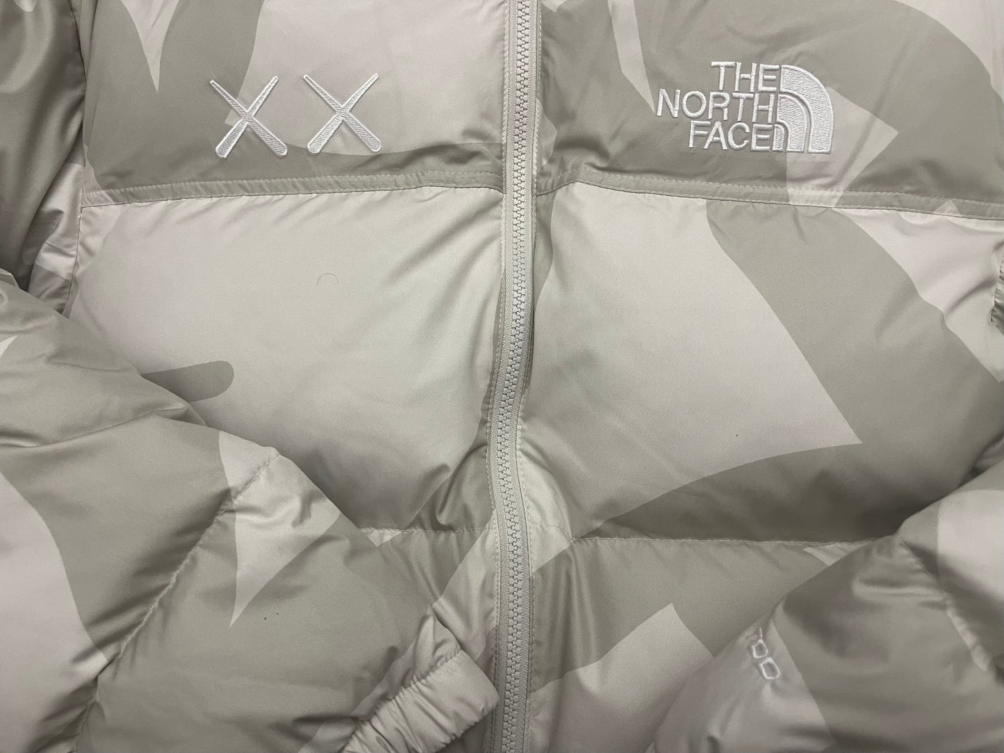 KAWS X The North Face Nuptse Moonlight Ivory