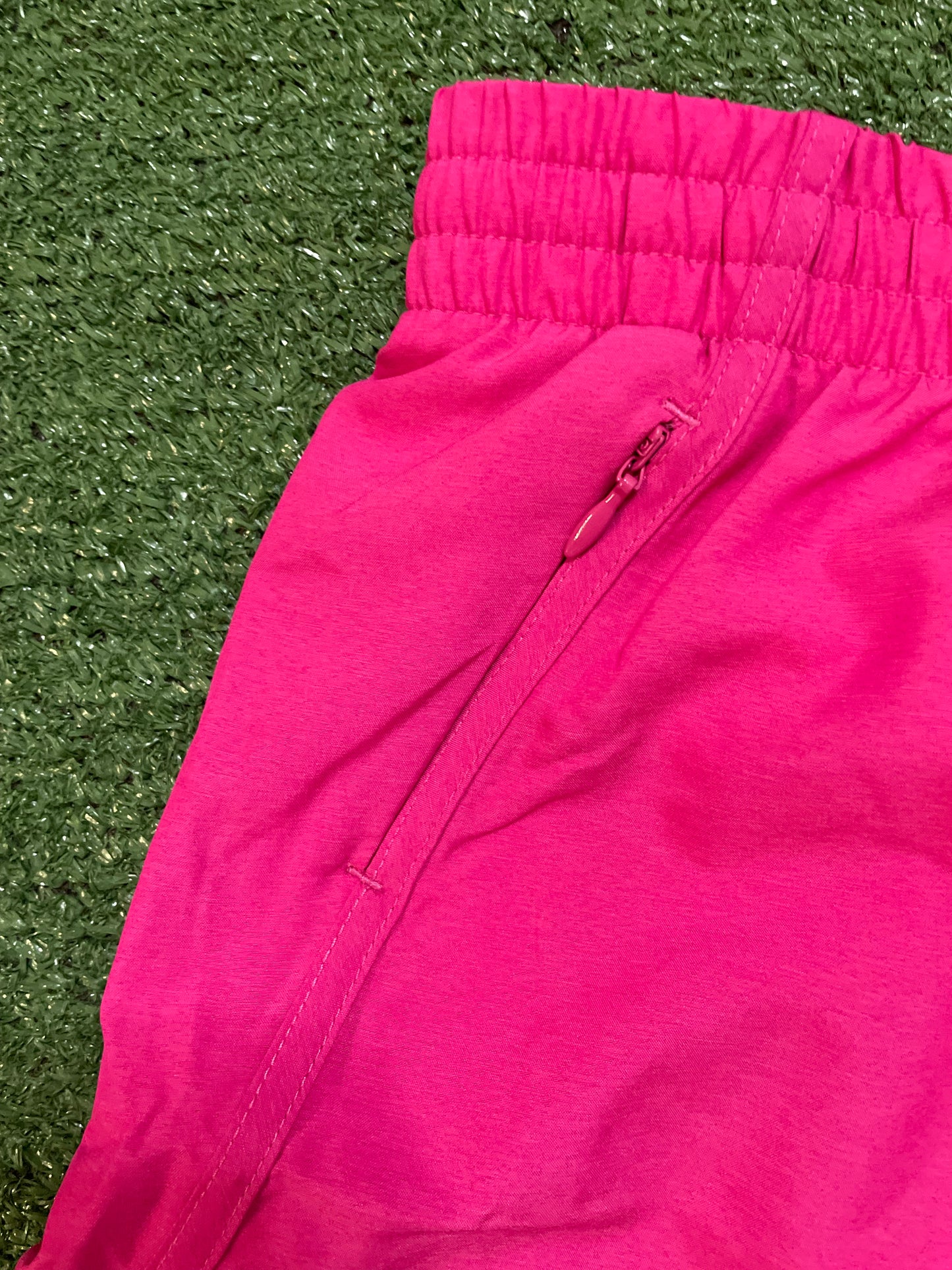 Under armour fly by pink shorts