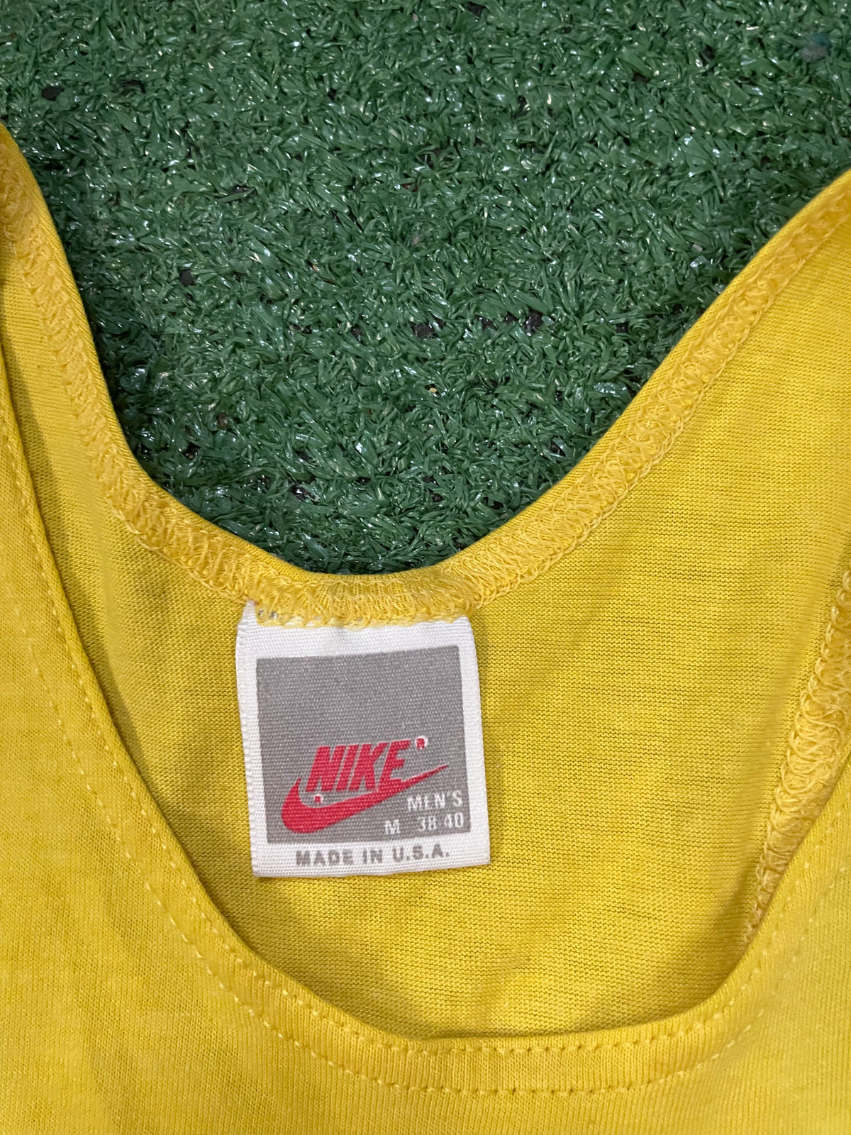 Vintage 1980s Nike repeat swoosh yellow tank top