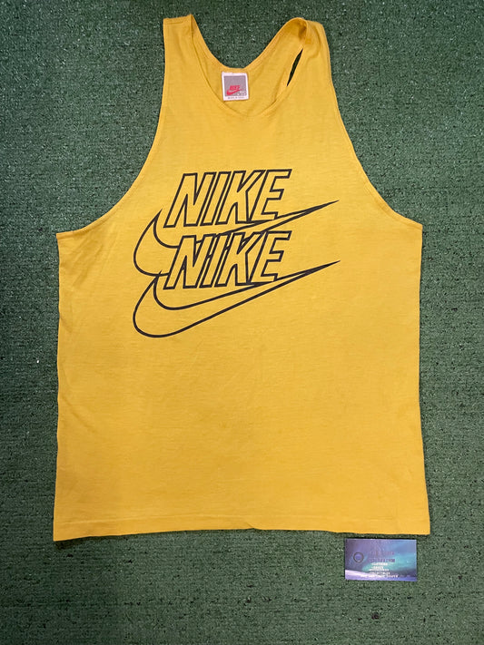 Vintage 1980s Nike repeat swoosh yellow tank top